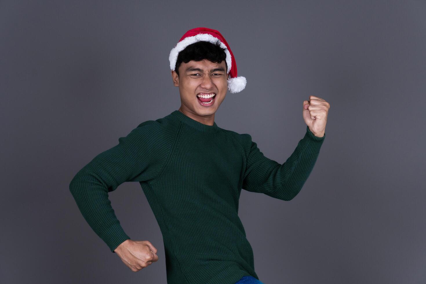Portrait Excited Young Asian Man Wearing Santa Hat, Christmas Holiday Concept Isolated photo