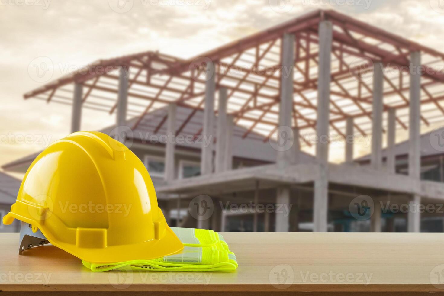 A hard hat and safety glasses on a table in front of a building photo