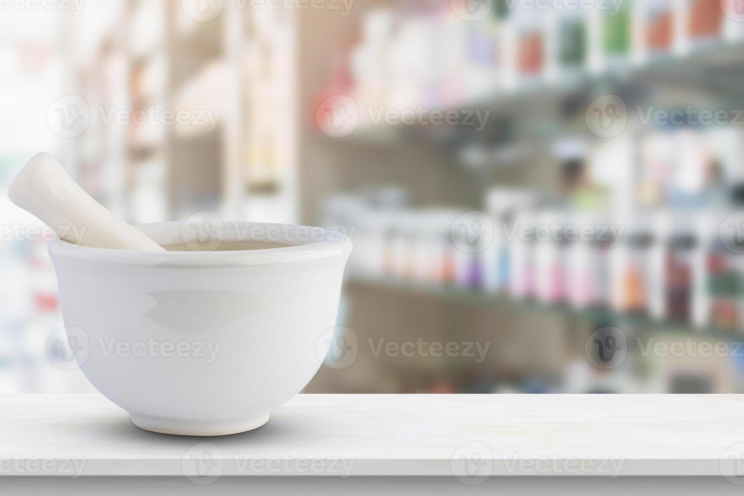 A white mortar and pestle sitting on a table in front of a pharmacy photo