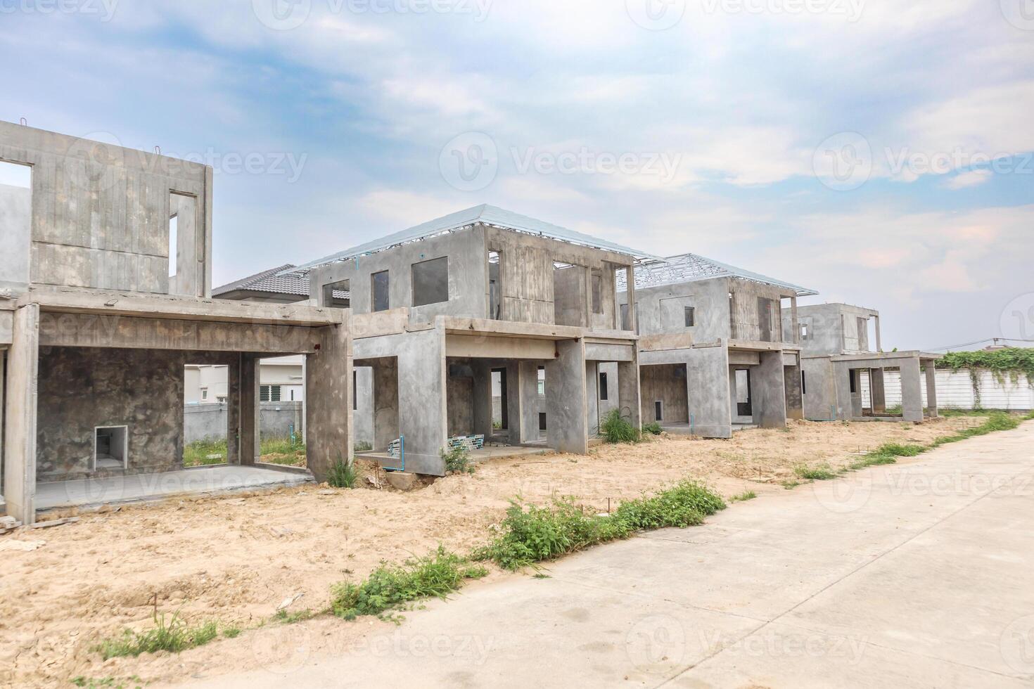 Concrete houses under construction in a residential area photo