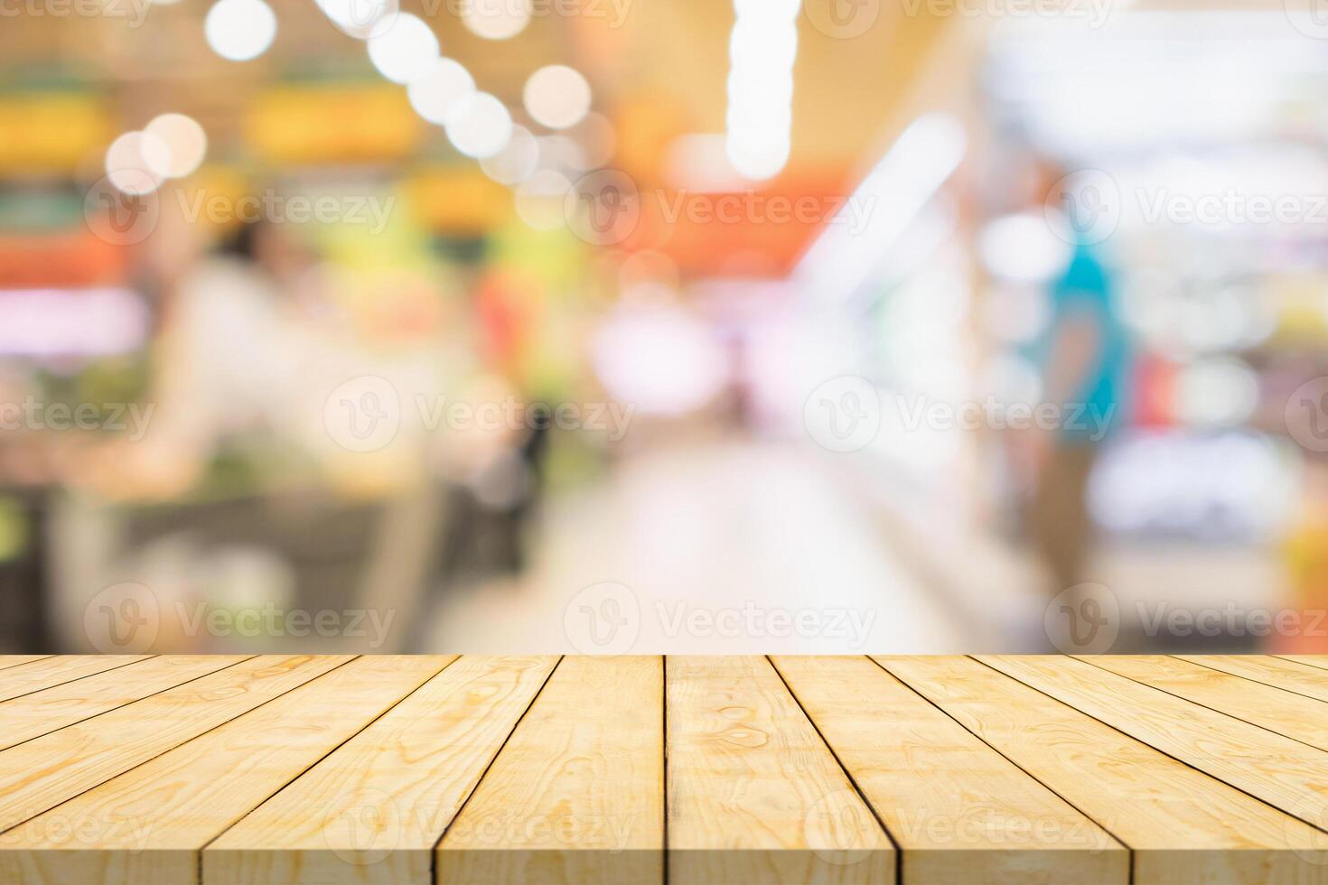 Wood table top in supermarket with blurred background photo