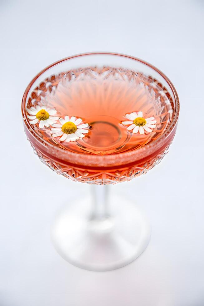 Elegant Floral Cocktail with Chamomile Flowers in Crystal Glass photo