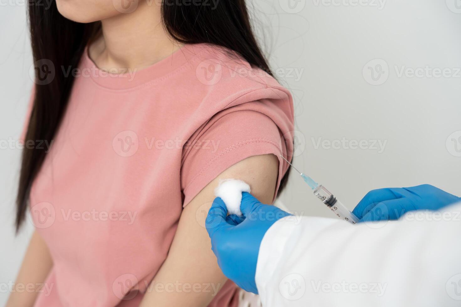 woman getting a vaccination to prevent pandemic. receive a dose of immunization virus vaccine from a nurse or doctor at the medical center, basic vaccine, alternative vaccine, vaccine for risk group photo