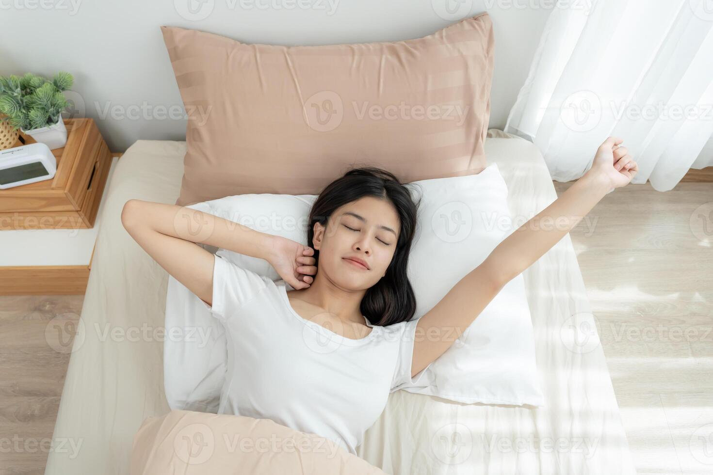 Simple lifestyle, Asian woman wakes up from good sleep on weekend morning, takes some rest, relax in comfortable bedroom at hotel window, happy lazy day, enjoy work life balance photo