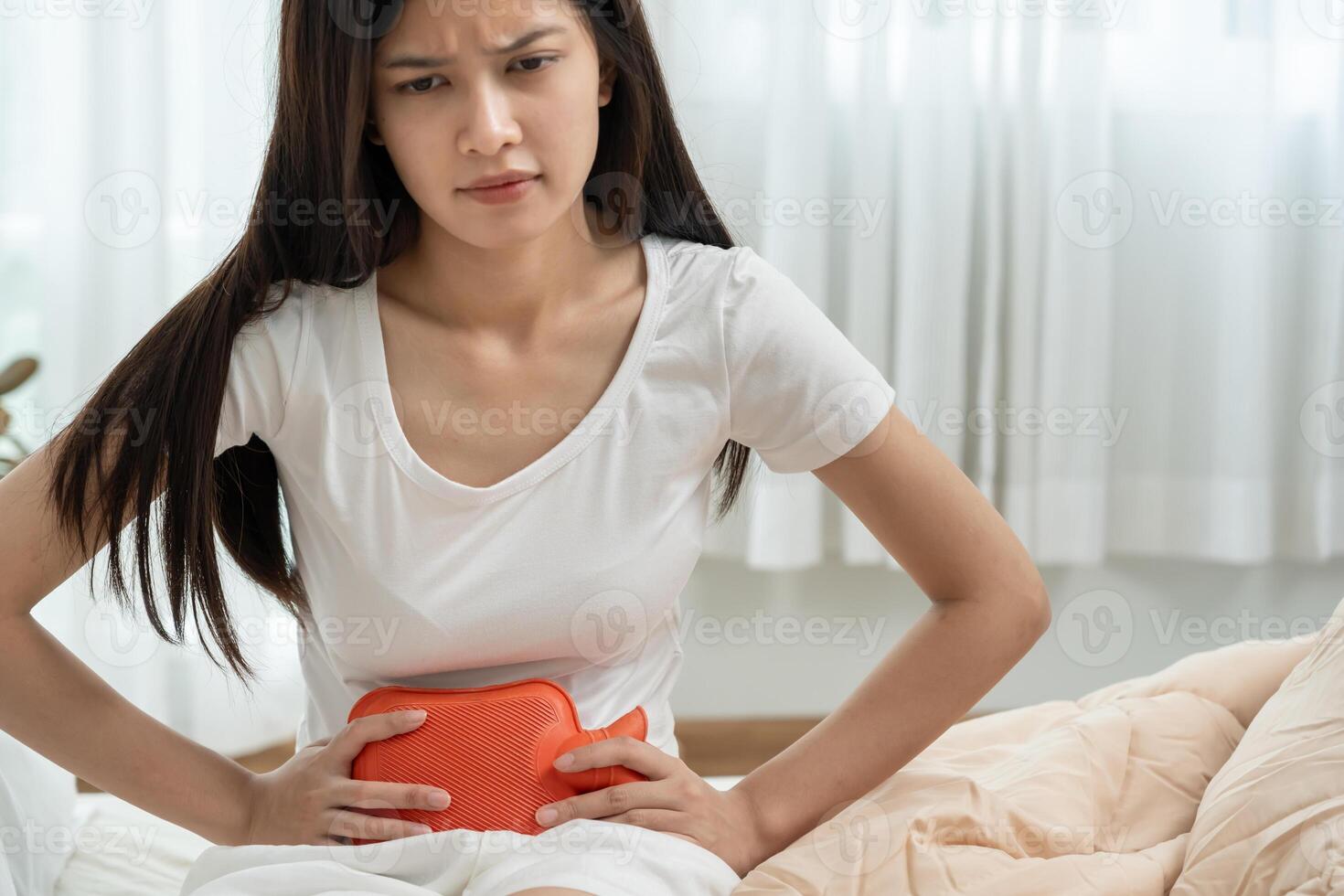 stomach ache. Asian women have abdominal pain, indigestion, gastritis, menstrual cramps, flatulence, diarrhea, distention, colon cancer, belly inflammation problem. suffer food poisoning. photo