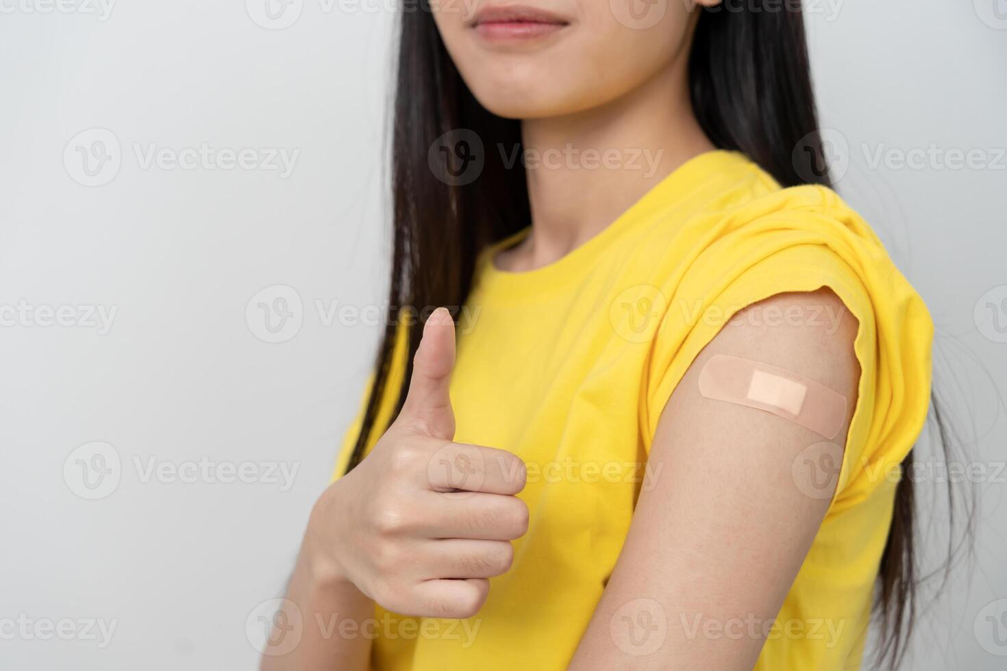 woman show after getting a vaccination. receive a dose of immunization virus vaccine from a nurse or doctor at the medical center, basic vaccine, alternative vaccine photo