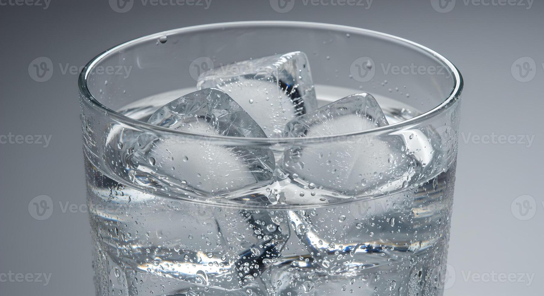 Macro close-up of glass with ice water, cold and realistic. photo