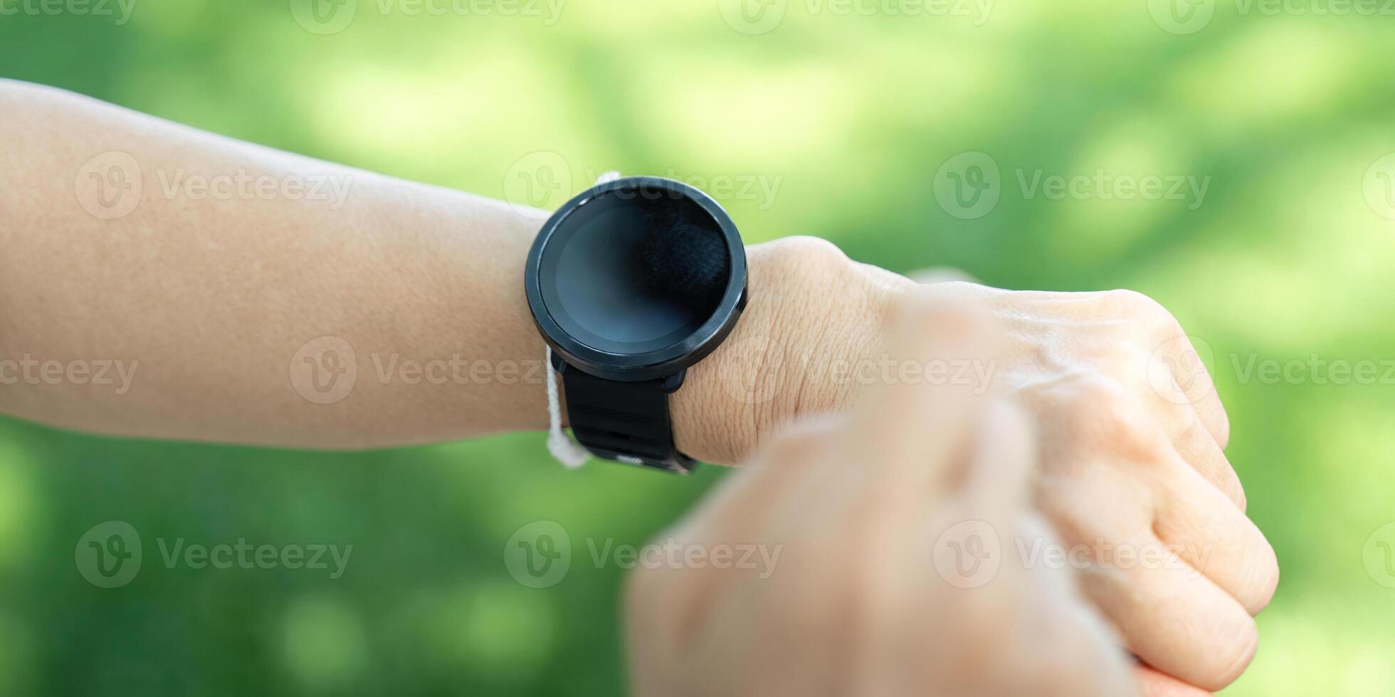 Seniors using smart technology for health monitoring outdoors photo