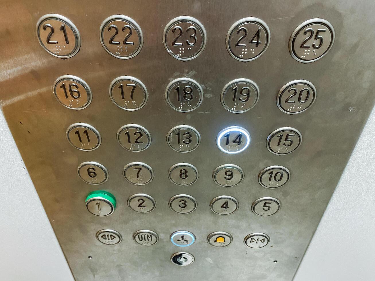 This image provides a detailed closeup view of elevator buttons, specifically highlighting the sleek and shiny silver button that grants access to the highly soughtafter 21st floor photo