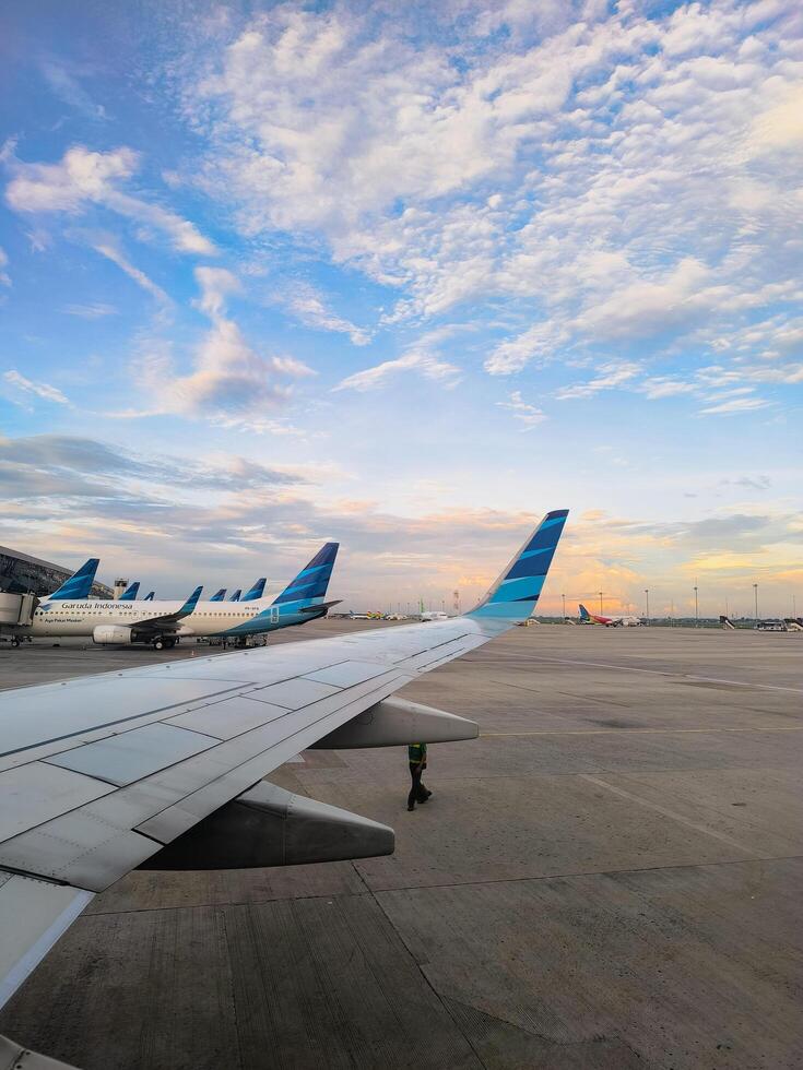 a view of an airplane wing from the top of an airport photo