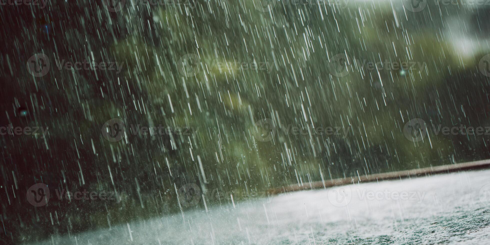Dramatic close-up captures the intense downpour of rain creating a refreshing scene. photo