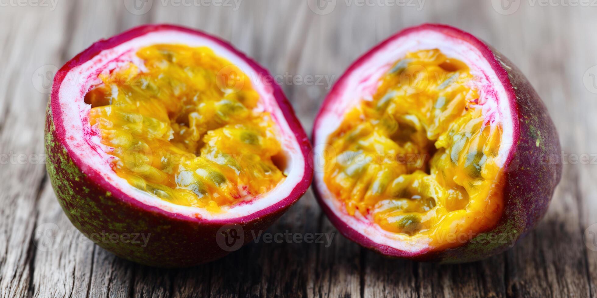 Two halves of a passion fruit, showcasing the vibrant yellow pulp and seeds. photo