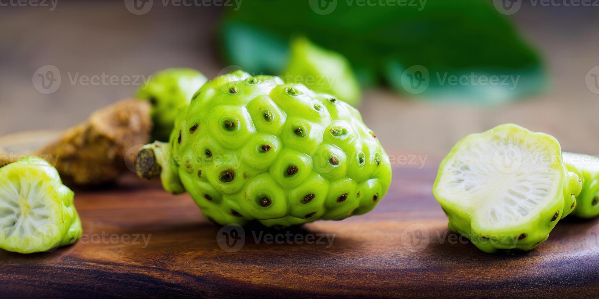 Vibrant green noni fruit showcases its bumpy texture and nutritional value on a wooden background. photo