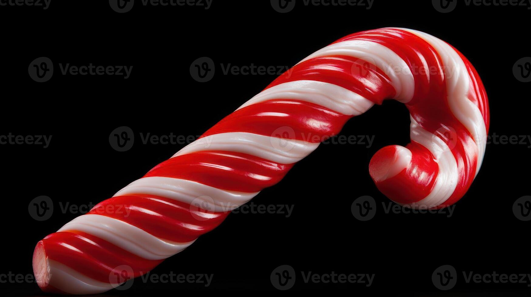 Festive red and white candy cane against a black background. photo