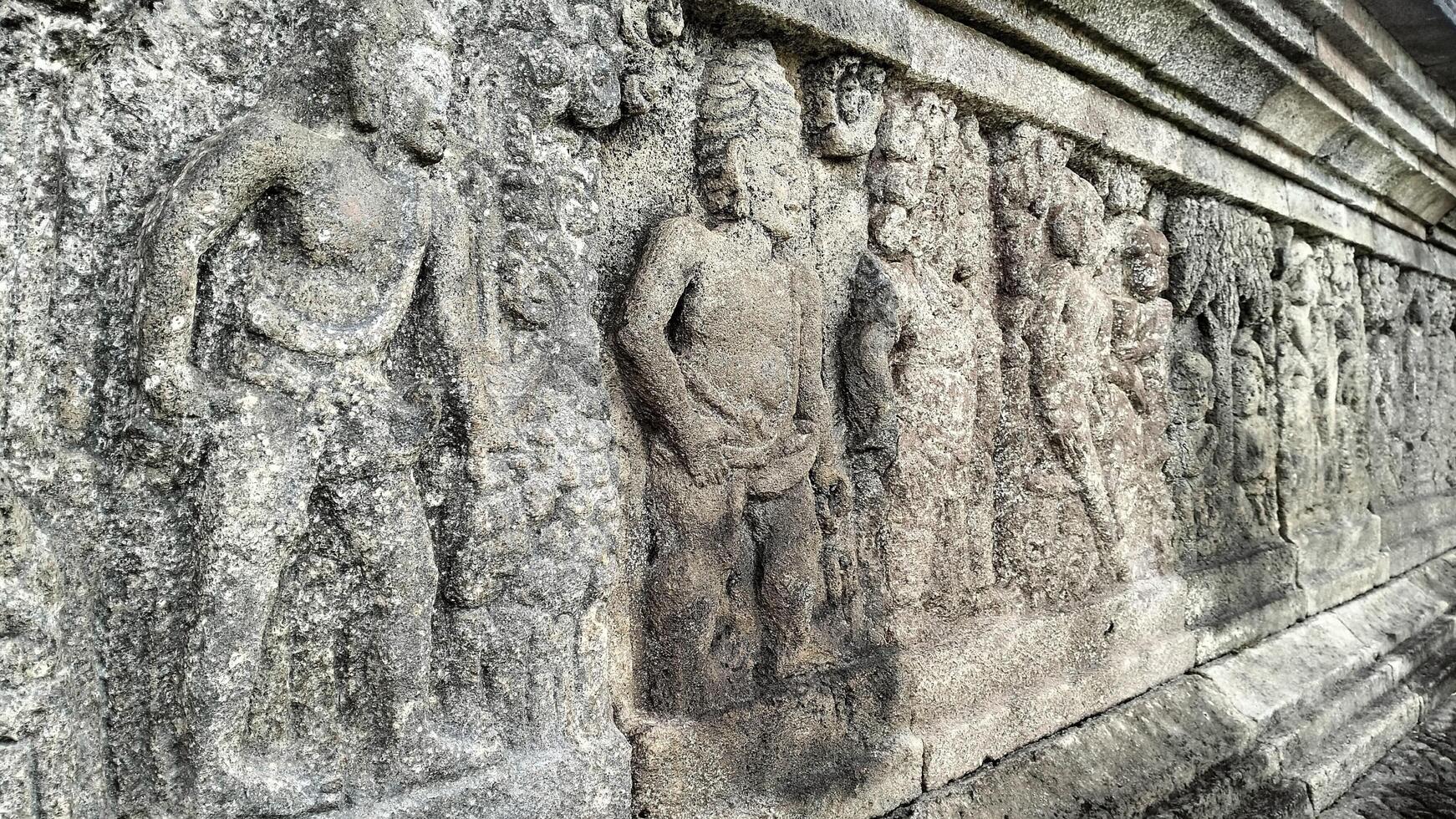 Ancient Bas-Relief Carvings Depicting Figures on Stone Temple photo