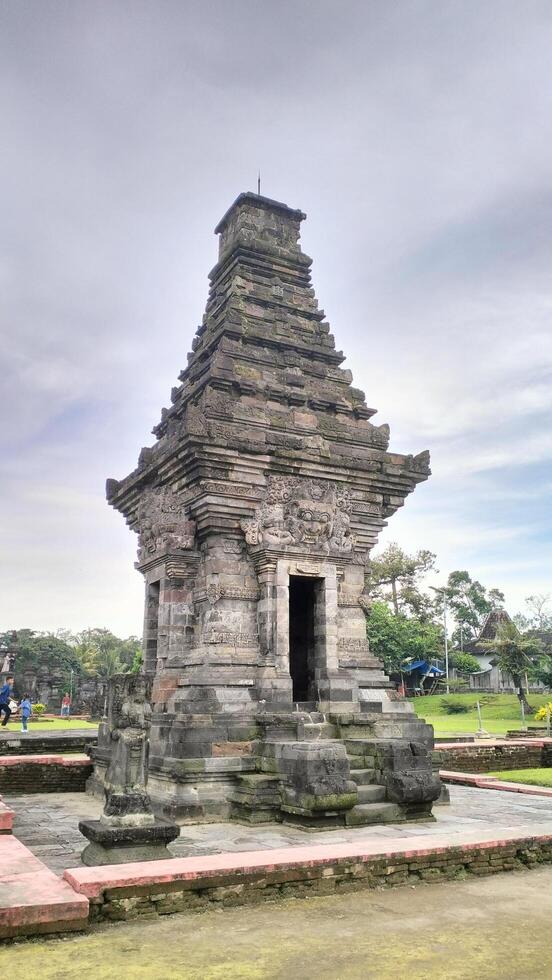 Ancient Javanese Hindu temple with intricate stone carvings and traditional architecture photo