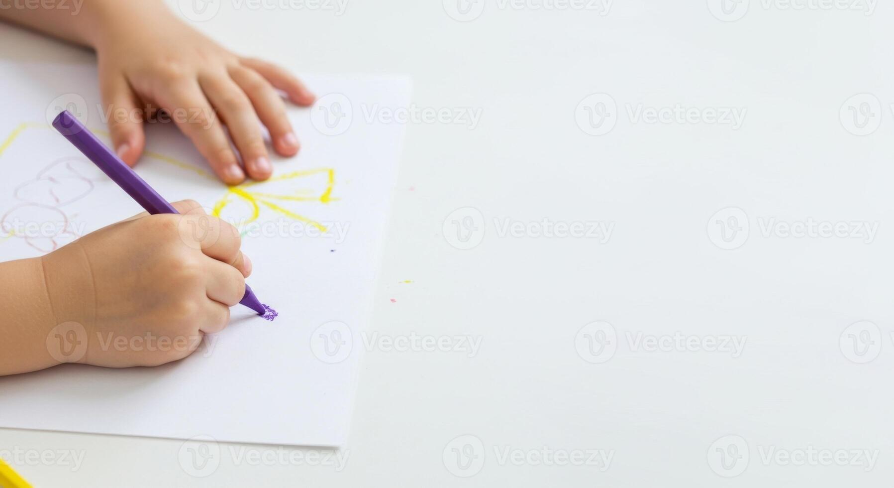 Child's Hand Drawing with Purple Marker on White Paper, Close-Up View, Creative Process. photo