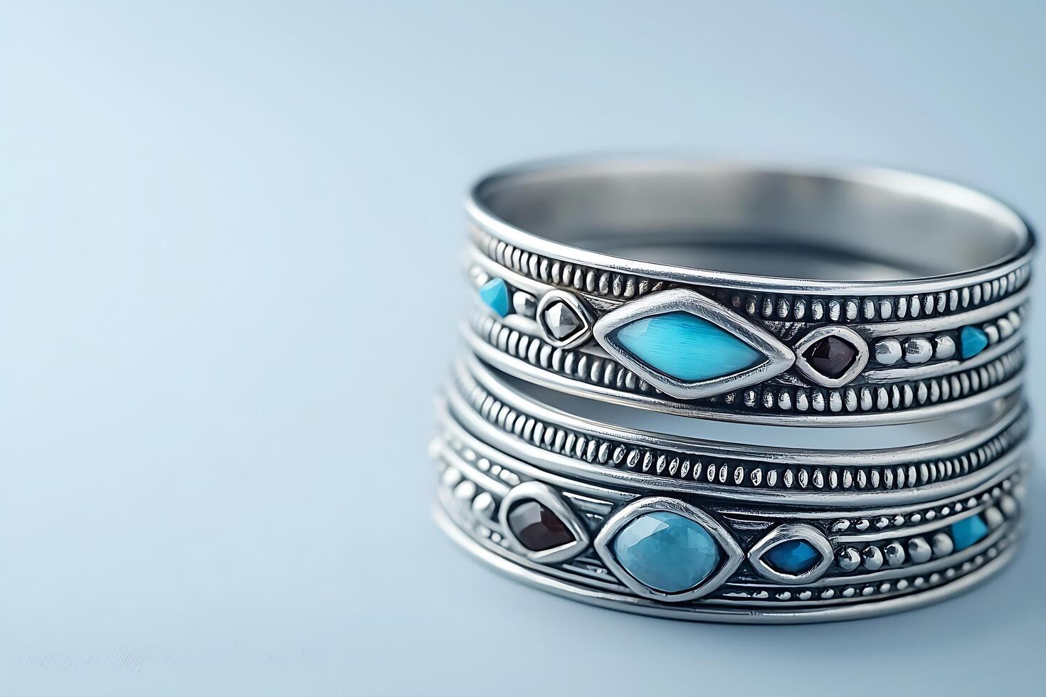 Close-up of Two Silver Rings Adorned with Turquoise and Garnet Stones. These intricately designed rings showcase beautiful gemstone details. photo