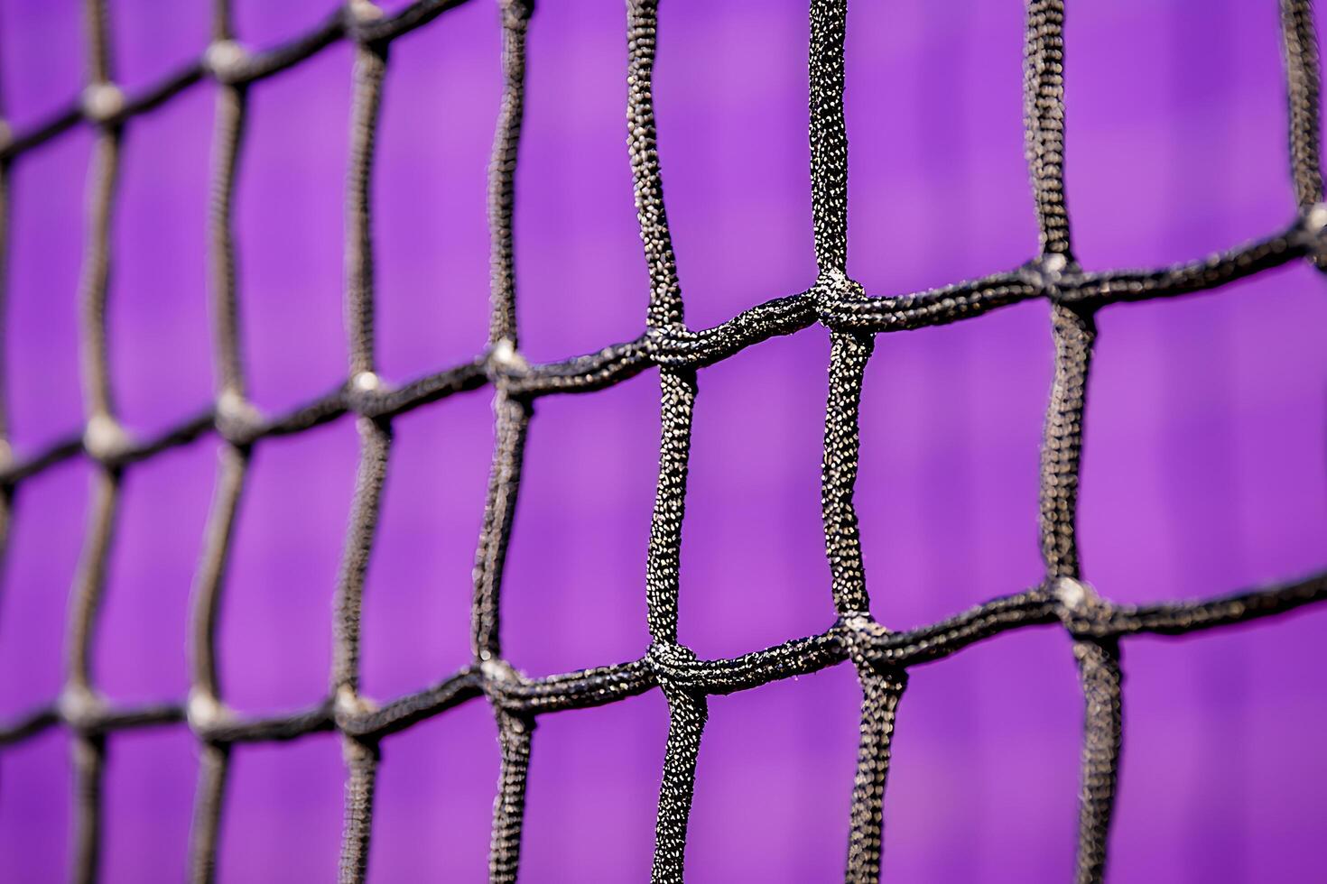 Close-up of Interwoven Netting Against a Vibrant Purple Background. photo