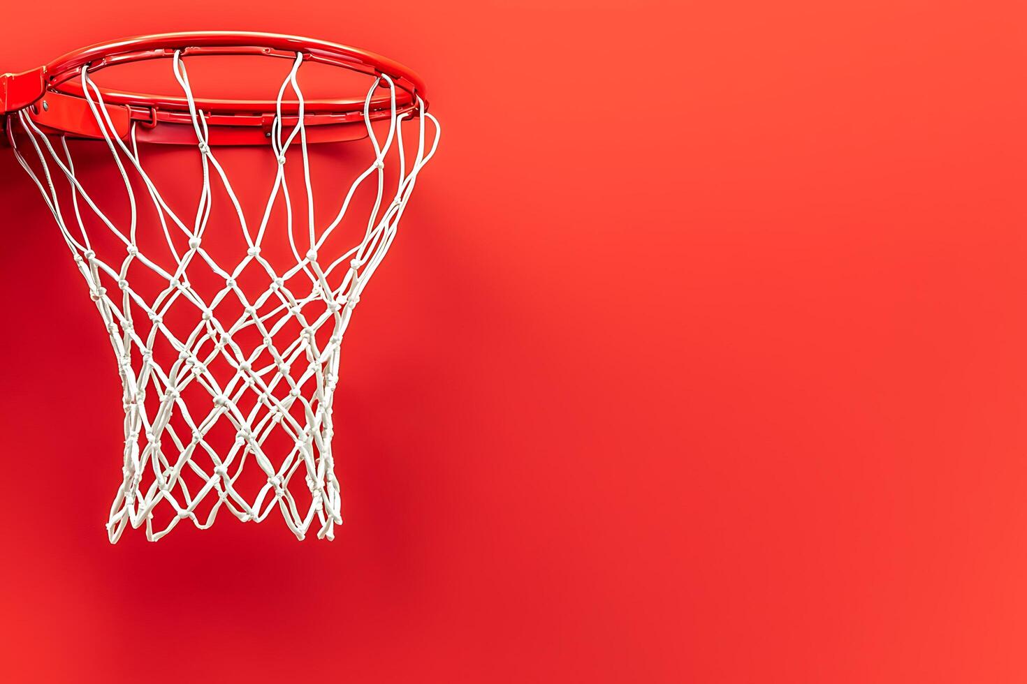 Red Basketball Hoop and Net Against a Solid Red Background. A striking image perfect for sports-related projects and designs. photo