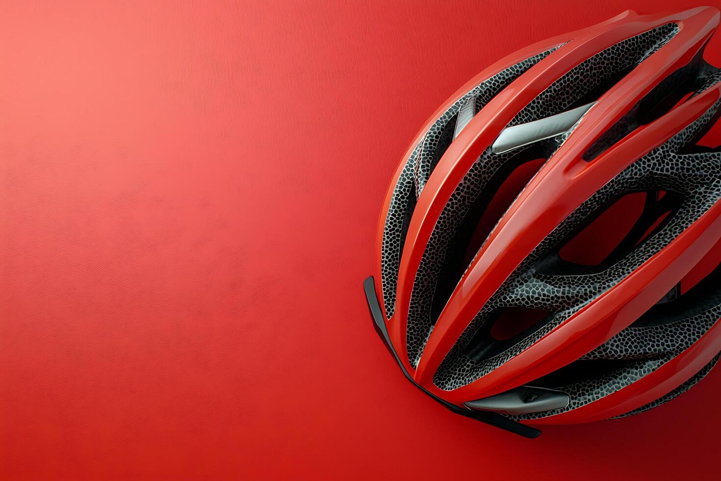 Red and Black Bicycle Helmet on Red Background Safety Gear for Cycling Enthusiasts. photo
