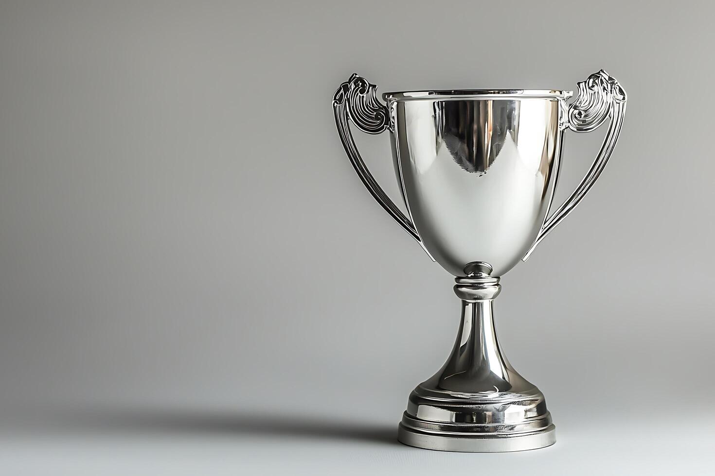 A Shiny Silver Trophy on a Neutral Background. A perfect image for celebrating success and achievement. photo