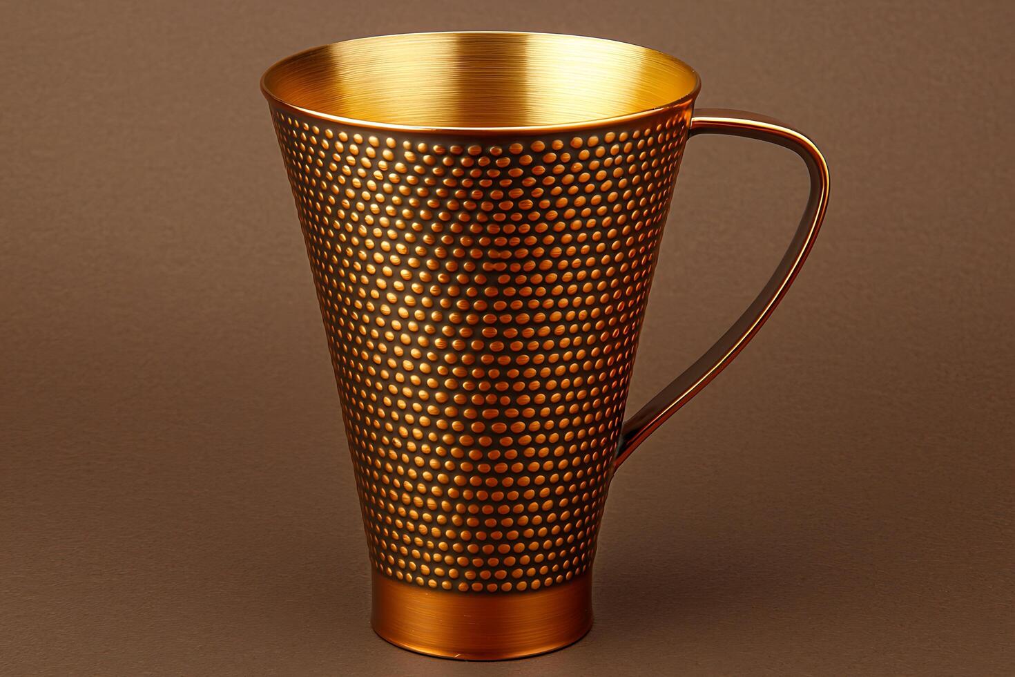 Elegant Gold and Brown Metal Mug with Dotted Pattern. A stylish drinking vessel perfect for showcasing luxury brands or adding a touch of sophistication to your design projects. photo