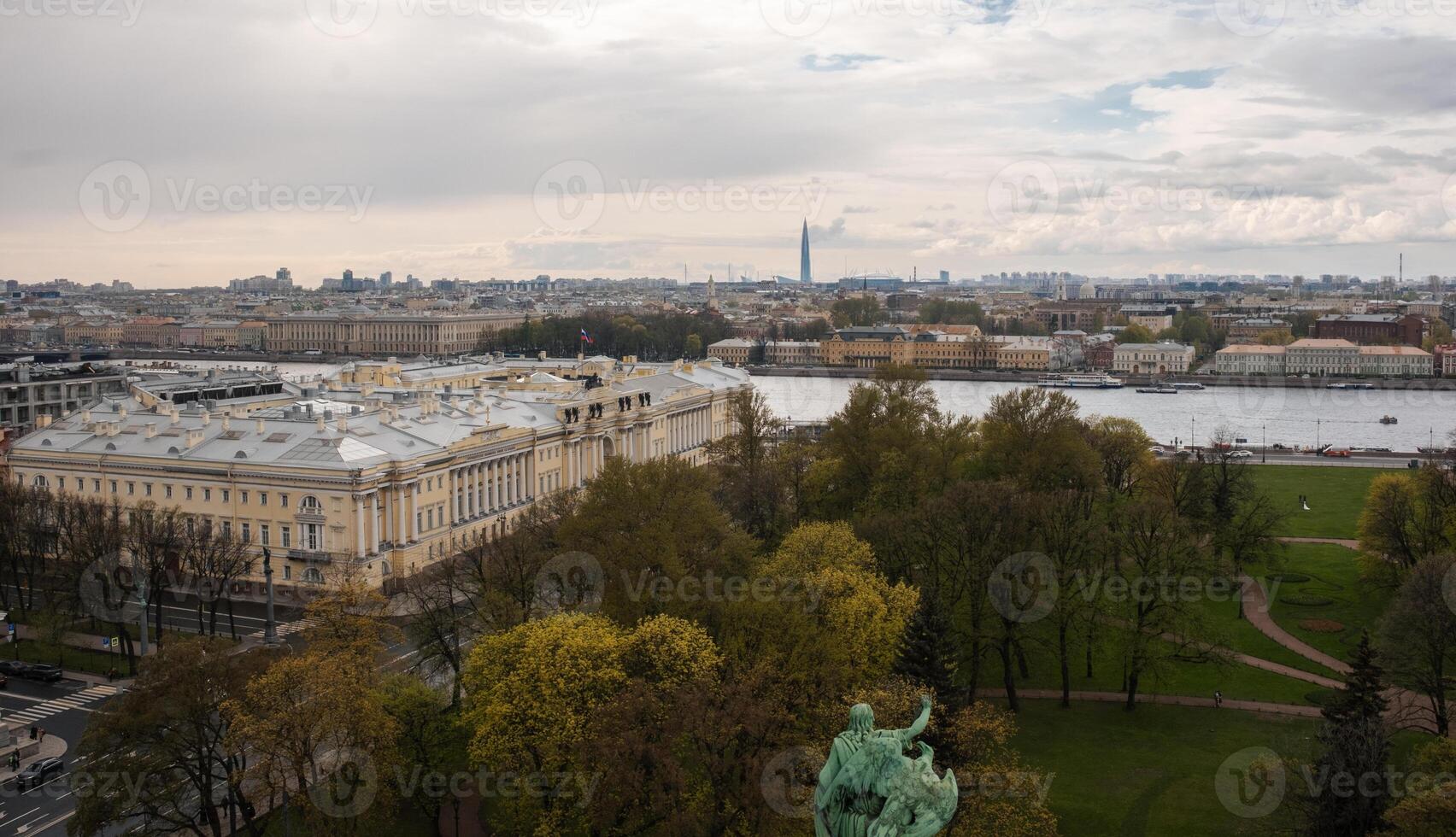 Skyline View of St. Petersburg With Green Parks and River at Dusk Highlighting the Citys Historic Architecture and Modern Structures photo