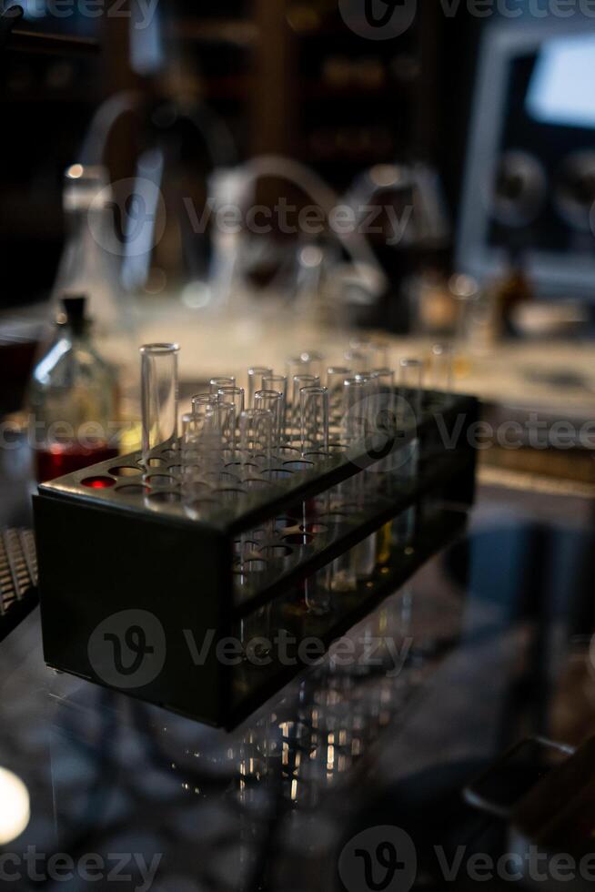 Laboratory Experiment With Glass Test Tubes and Equipment on a Reflective Surface During Evening Hours photo
