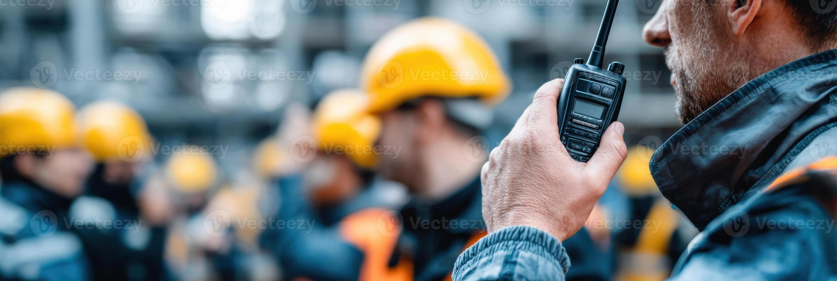 Man Communicates With Team Using Walkie-Talkie During Collaborative Work on Construction Site in Urban Environment photo