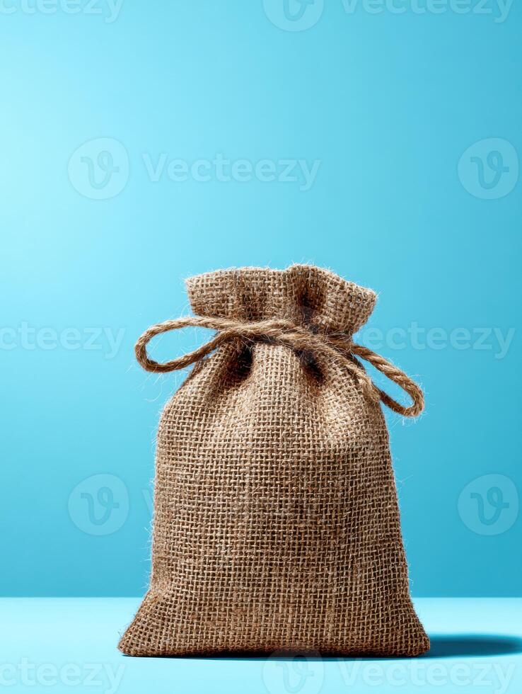 Eco-friendly Burlap Packaging Stands out Against a Bright Blue Background Reflecting Sustainability and Natural Materials photo