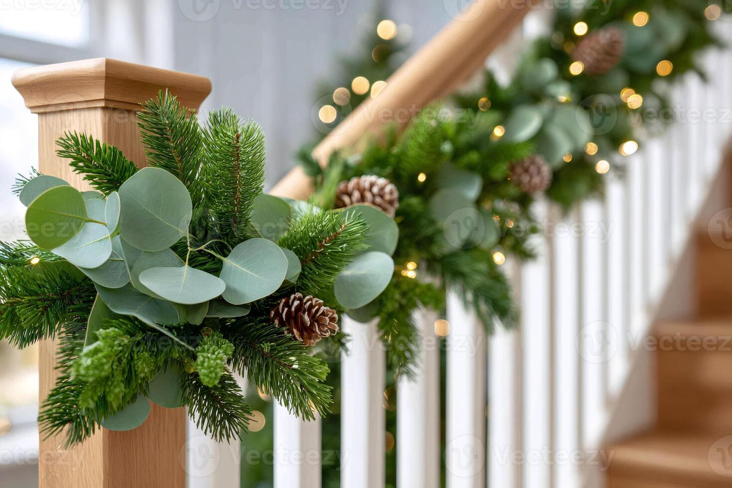 Christmas garland decorating wooden banister with eucalyptus and pine cones photo