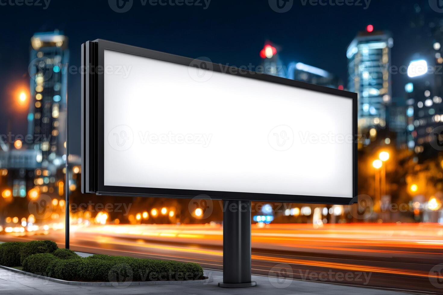 Blank billboard by busy road at night showing motion blur of traffic photo