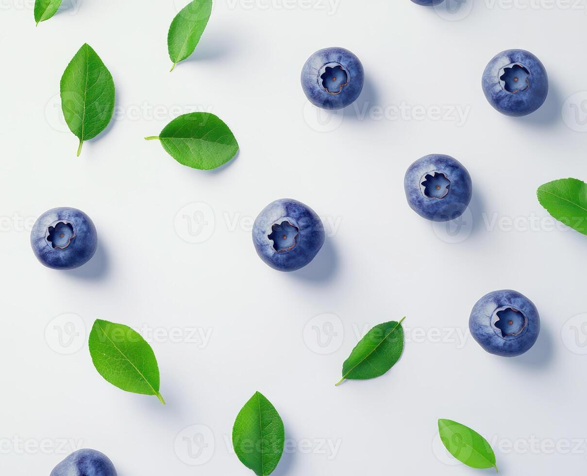 Fresh blueberries and leaves on a white surface photo