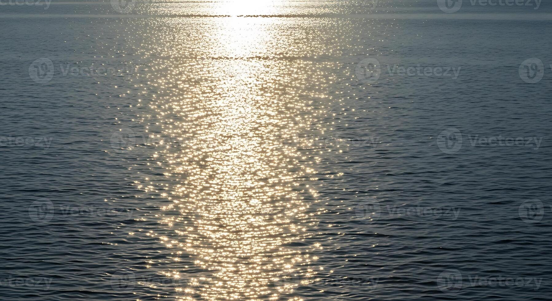 A boat is in the water with the sun shining on it photo