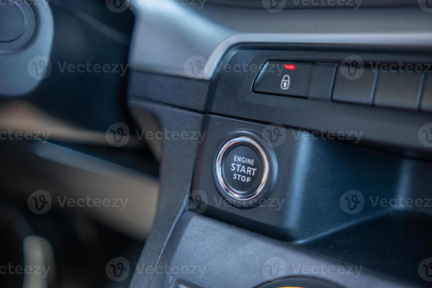 Close-up View of an Ignition Button in a Vehicles Interior During a Bright and Sunny Day photo