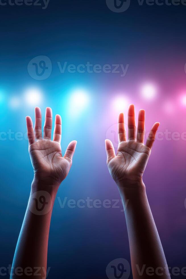 Engaging hands gesture passionately during a public speaking event under vibrant lighting photo