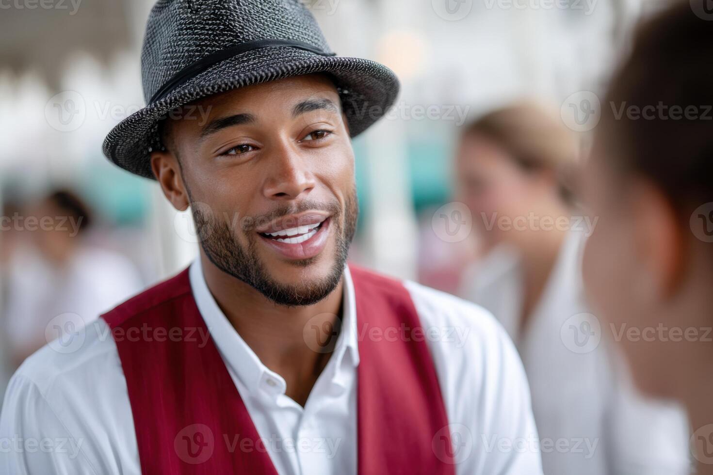 Diverse ticket collector welcomes guests at vibrant amusement park entrance photo