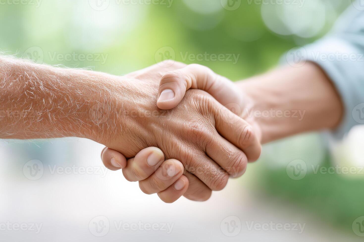 Close-up of hand shaking gesture symbolizing reconciliation and trust in peaceful park setting photo
