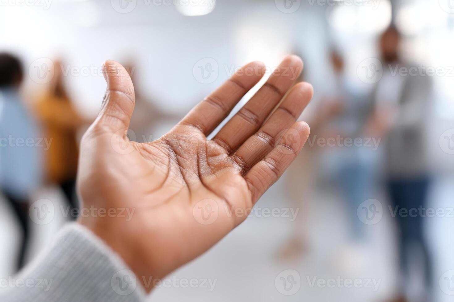 Hands reaching out to connect in a bright workspace, fostering community among employees photo