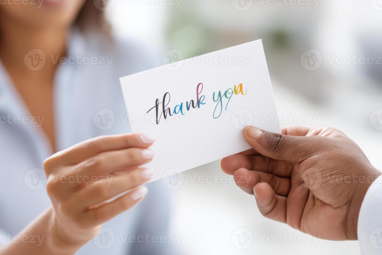 Hands exchanging a colorful thank you card to symbolize gratitude and recognition in a heartfelt moment photo