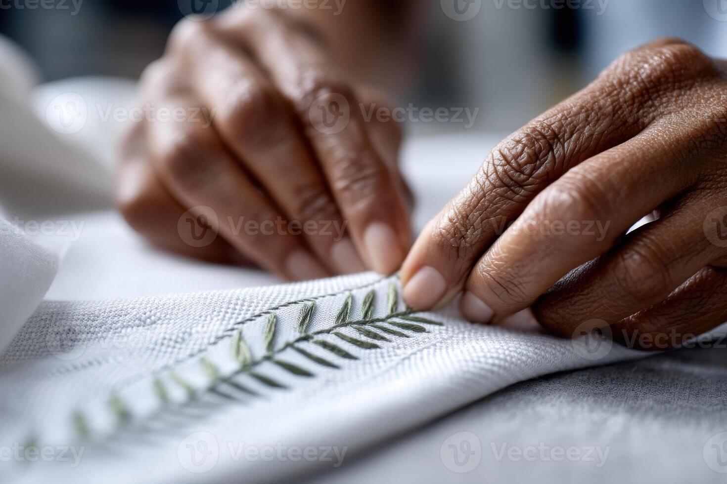 Hands create intricate embroidery patterns in a serene workspace during the daytime photo