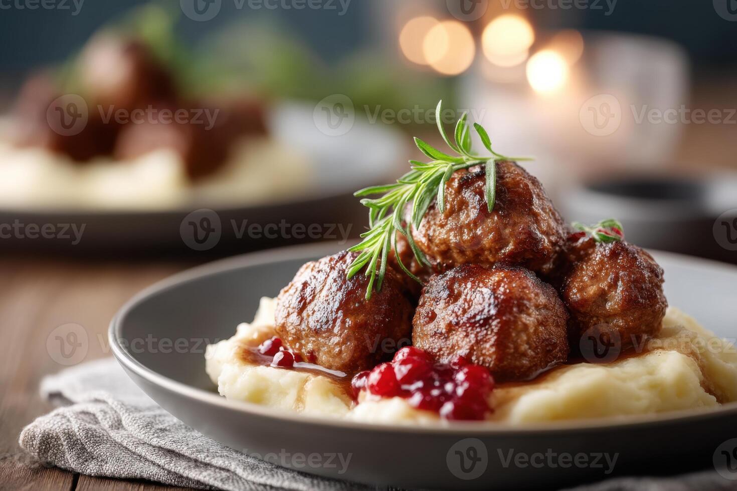 Delicious Swedish meatballs with creamy mashed potatoes and lingonberry sauce on a wooden table photo