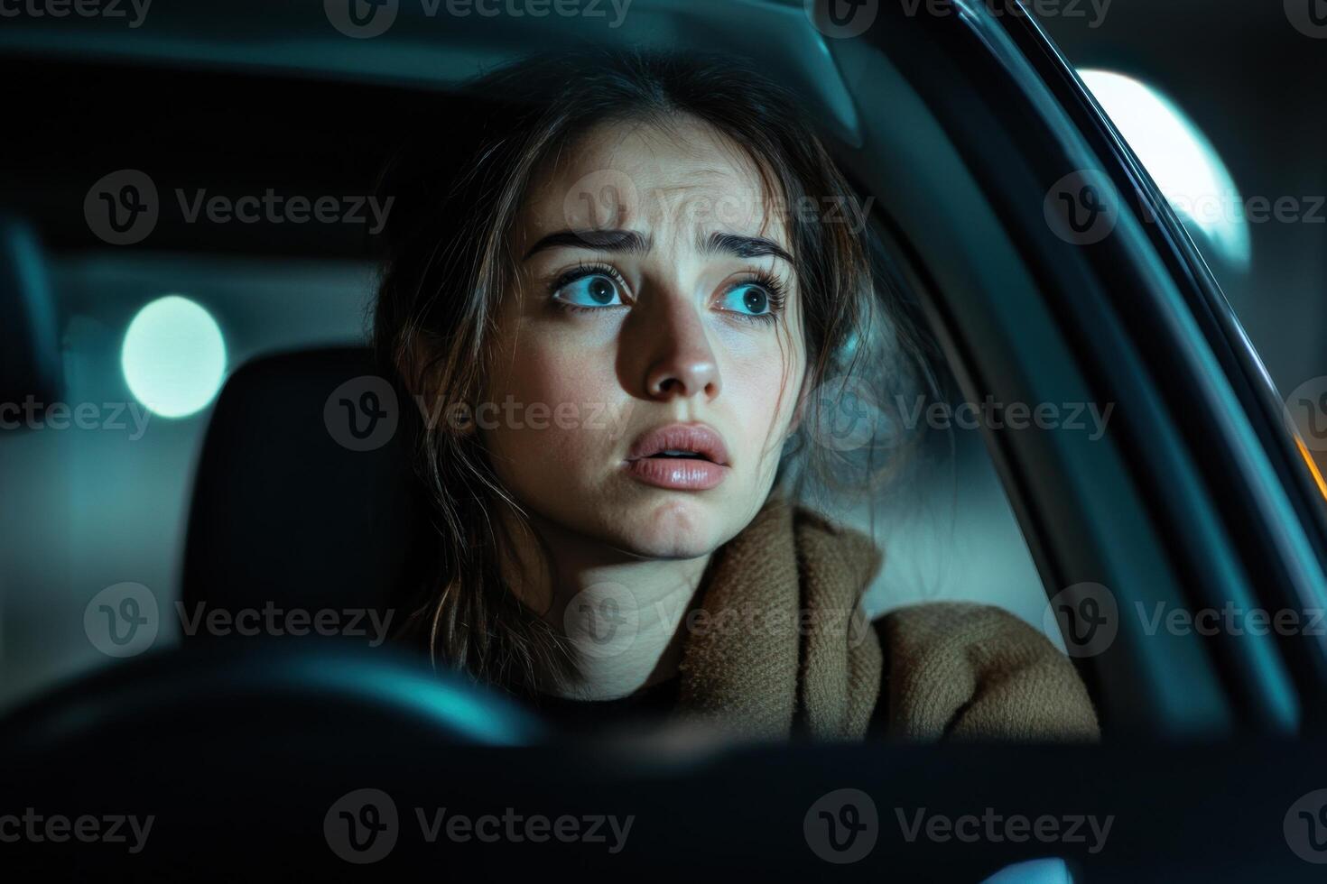 Young woman feels panic and distress after discovering her car is missing in a dimly lit parking garage photo