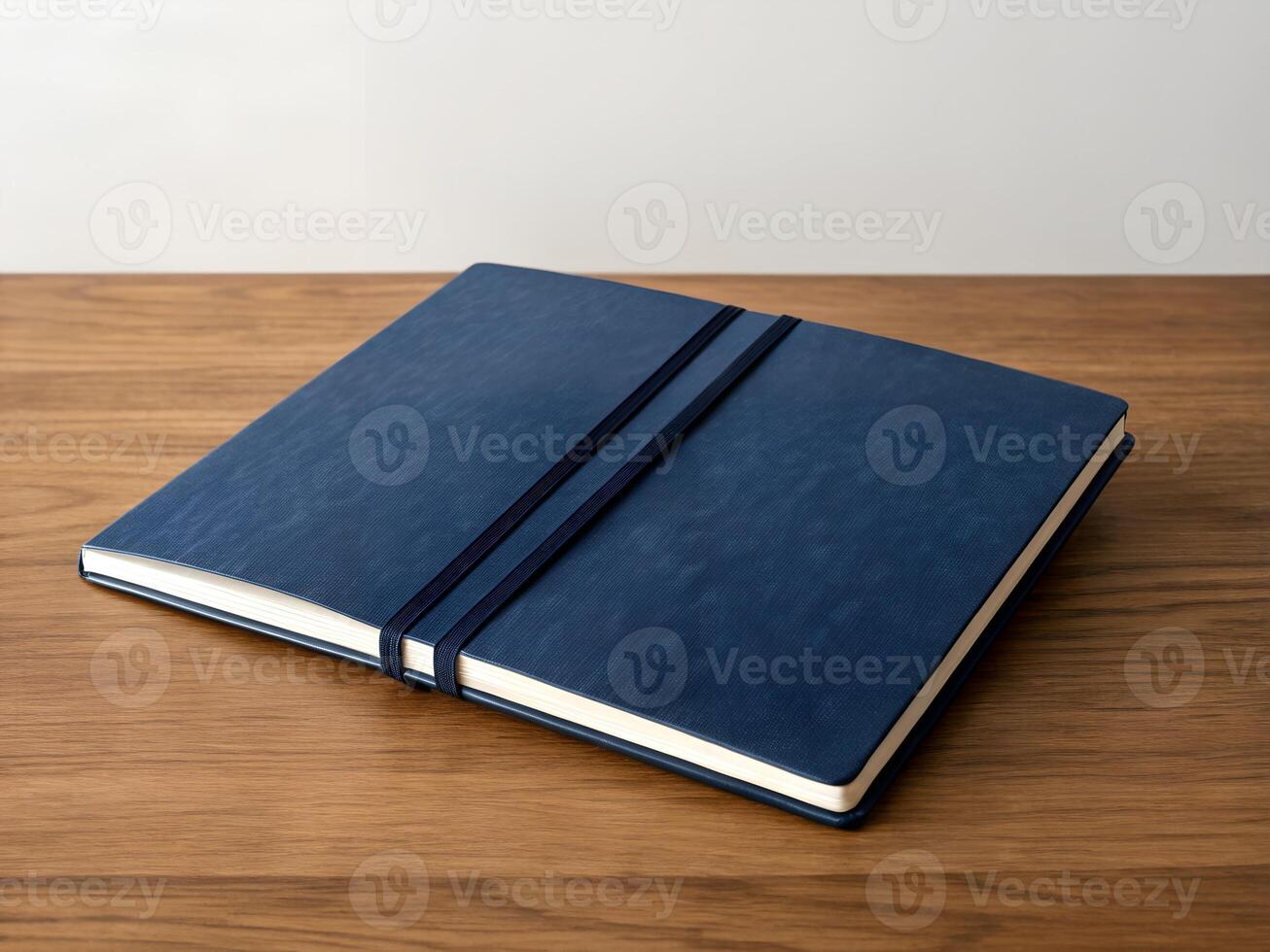 Closed Dark Blue Textured Notebook on Wooden Desk photo
