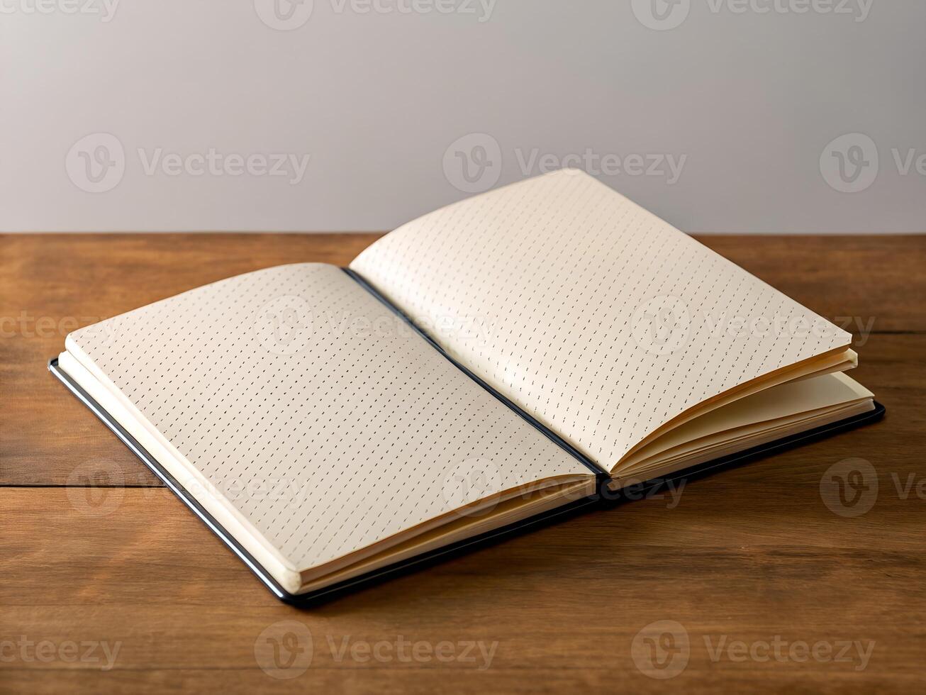 Open Notebook with Dot Pattern on Wooden Table photo