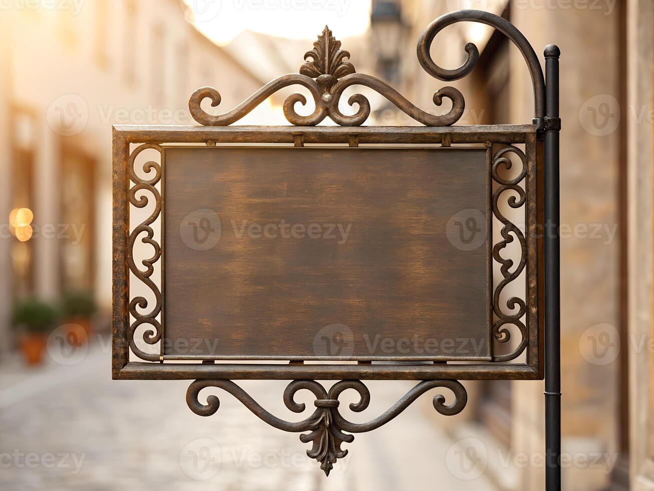 Blank Ornate Brown Metal Sign on Old Town Street photo