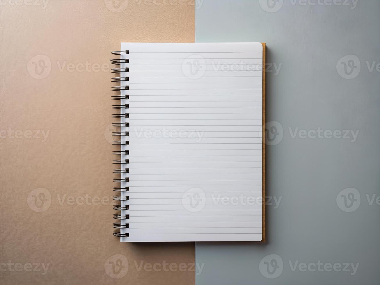 Blank Spiral Notebook on Beige and Blue Background photo