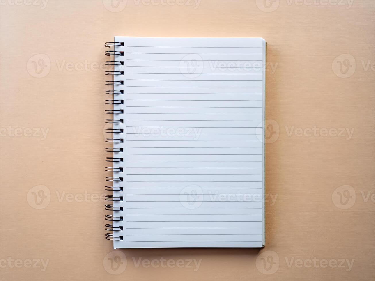 an open notebook with a spiral notebook on a beige background photo