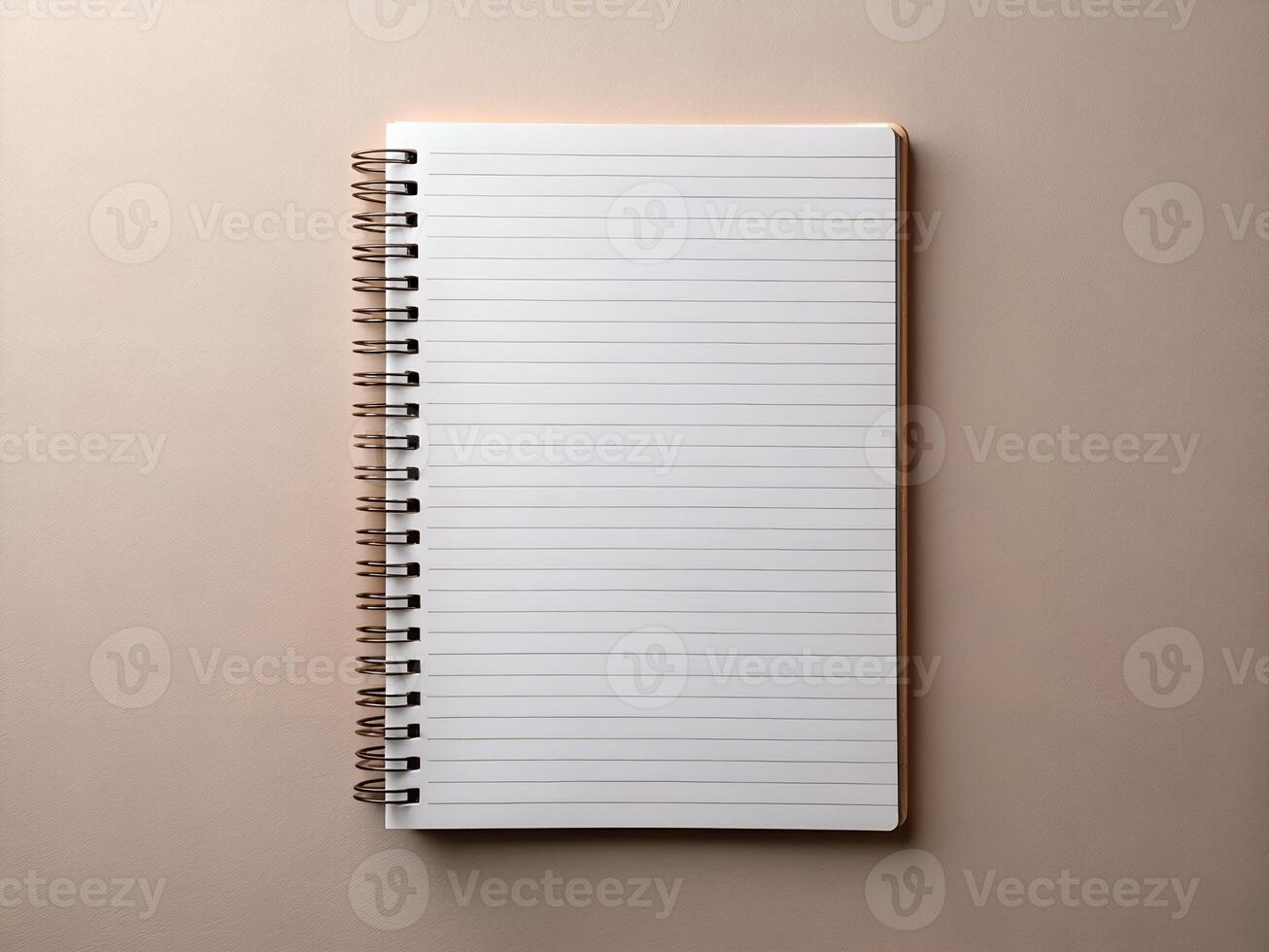 Blank Spiral Notebook with Rose Gold Binding on Beige Background photo